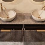 Rond hangend donker eiken badkamermeubel 160 cm met groevenfront, eiken blad en beige limestone waskom