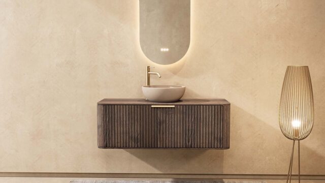 Rond donker eiken wastafelmeubel 120 cm met groevenfront, eiken blad en beige limestone waskom