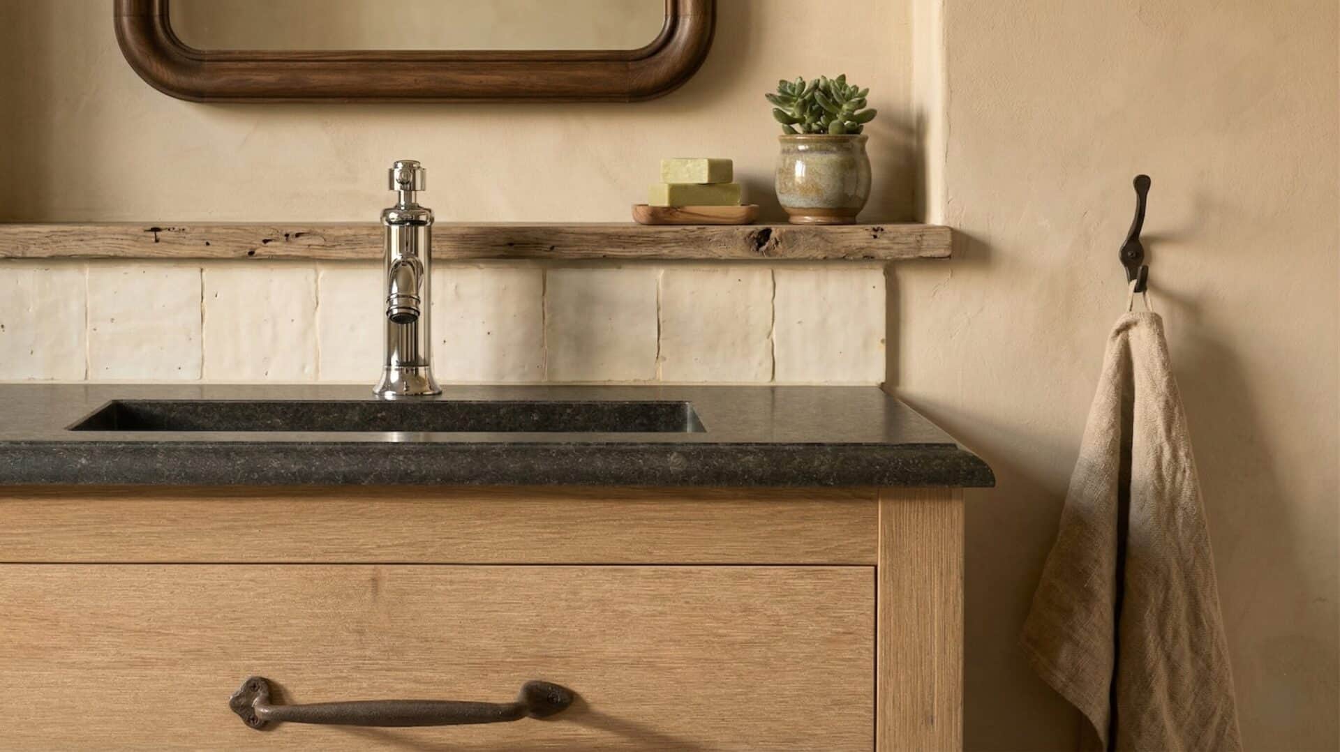 Landelijke badkamer met staand badkamermeubel met een granieten blad en landelijke wastafelkraan