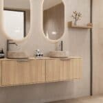 Rond hangend naturel eiken wastafelmeubel 160 cm met afgeronde hoeken en twee beige marmerlook waskommen