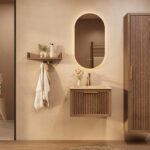 Het Riva badkamermeubel 60 in donker eiken ademt luxe en rust. Massief eiken met groevenfront, hoogwaardige softclose lades en een mat beige Mineraalsteen wastafel. De wastafel kan met of zonder kraangaten worden geleverd.