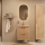 Het Riva badkamermeubel 60 in naturel eiken combineert ambachtelijk vakmanschap met moderne luxe. Gemaakt van massief eiken met ribbelfront, twee softclose lades en een mat beige Mineraalsteen wastafel. De wastafel kan met of zonder kraangaten worden