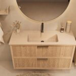 Het Riva badkamermeubel 120 in naturel eiken combineert ambachtelijk vakmanschap met moderne luxe. Gemaakt van massief eiken met ribbelfront, twee softclose lades en een mat beige Mineraalsteen wastafel. De wastafel kan met of zonder kraangaten worde