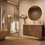Het Riva badkamermeubel 120 in donker eiken ademt luxe en rust. Massief eiken met groevenfront, twee hoogwaardige softclose lades en een mat beige Mineraalsteen wastafel. De wastafel kan met of zonder kraangaten worden geleverd.